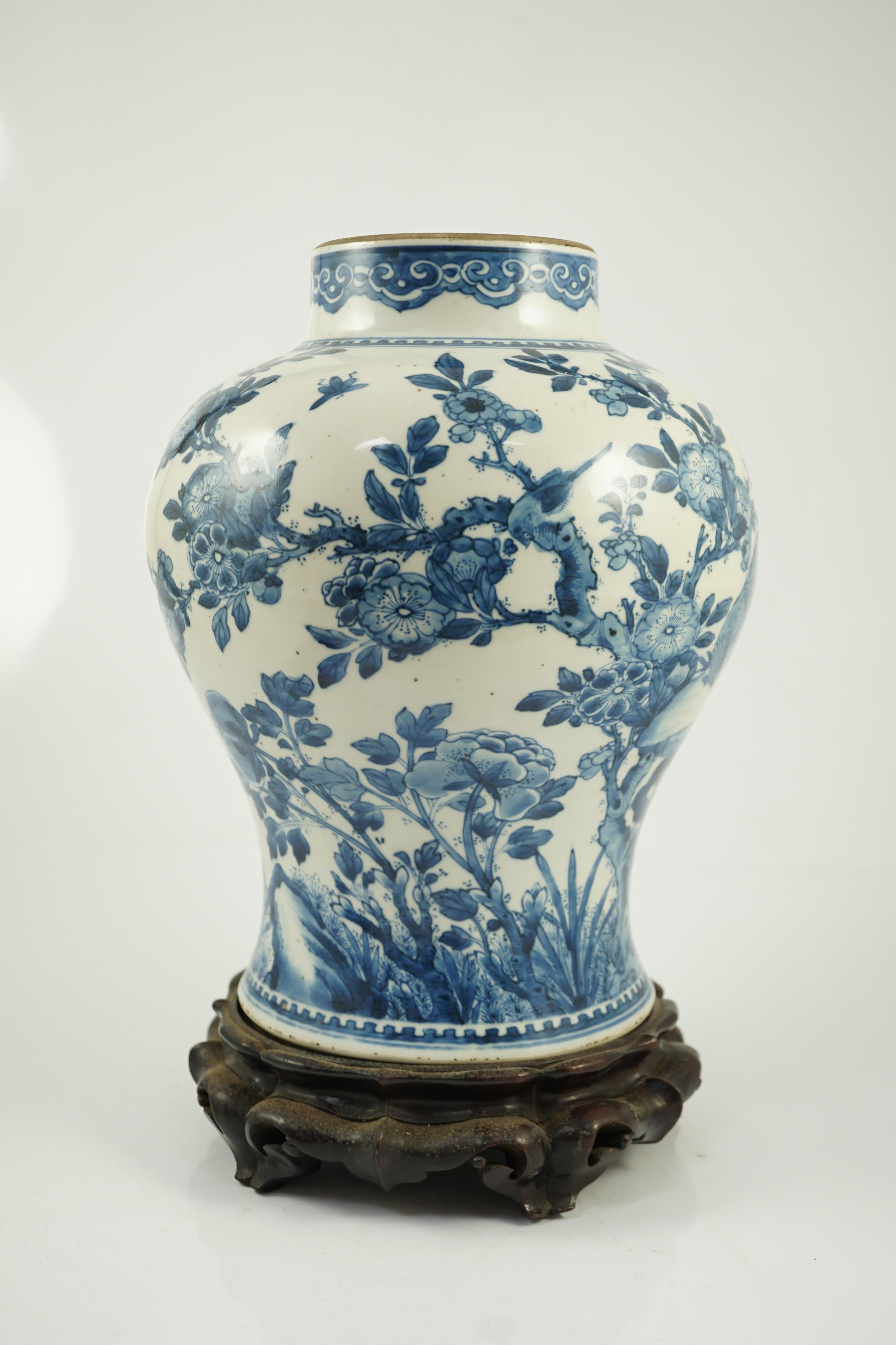 A Chinese blue and white ‘birds and blossom’ baluster vase, Kangxi period